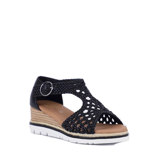 The Bay Lane Rumor Black Women's Woven Leather Wedge Sandal features an open toe, ankle strap with buckle, cushioned footbed, tan insole, white wedge sole, and a layered rope-detailed platform heel.