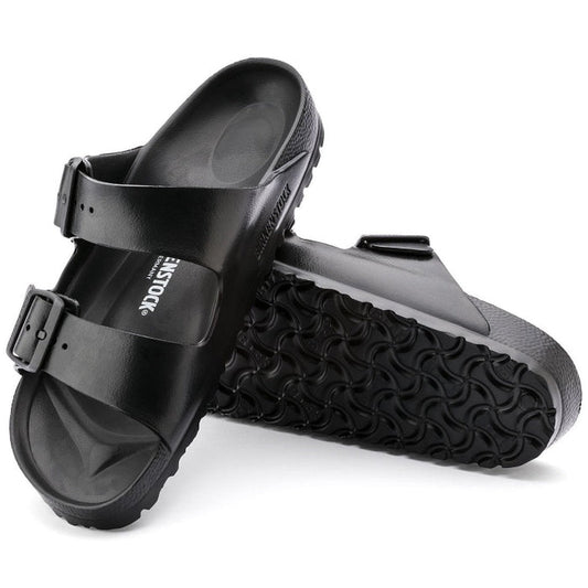 a pair of Birkenstock Arizona EVA Black Narrow Width with double straps, one over the foot and one over the toes with buckle adjustment. Staps are linked at the sides of the foot. Made of EVA a plastic like material, suitable fot being around water