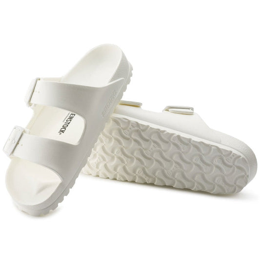 a pair of Birkenstock Arizona EVA White Narrow Width with double straps, one over the foot and one over the toes with buckle adjustment. Staps are linked at the sides of the foot. Made of EVA a plastic like material, suitable fot being around water