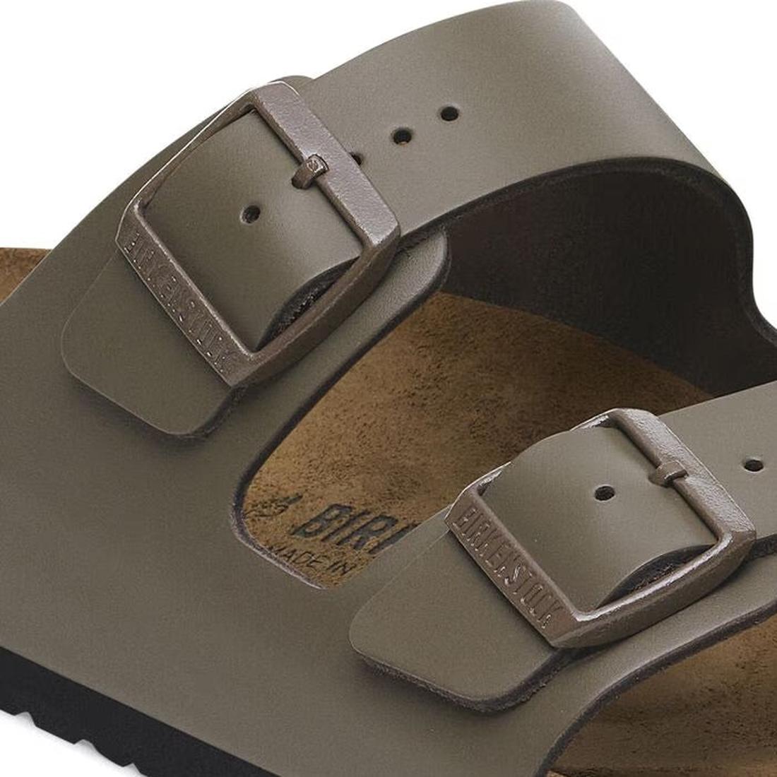 Close-up of a Birkenstock Arizona Smooth Natural Leather sandal in concrete grey, regular width, featuring two wide straps with metal buckles engraved with BIRKENSTOCK and an anatomically formed footbed., 47484, 4066648922902, 4066648922940, 4066648922988