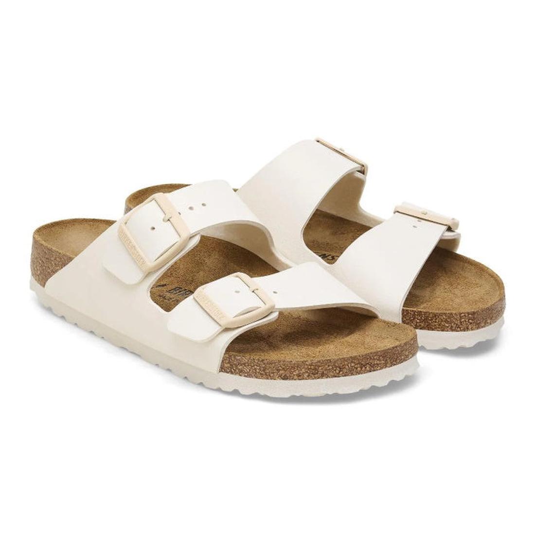 Pair of whiteBirkestock slides arizona sandals with cork soles on a white background.
4066648369509,
4066648369547,
4066648369585,, 46716, 46717, 4066648369509, 4066648369547, 4066648369585, 46721, 46722, 46723, 46724, 46725, 46726, 46727