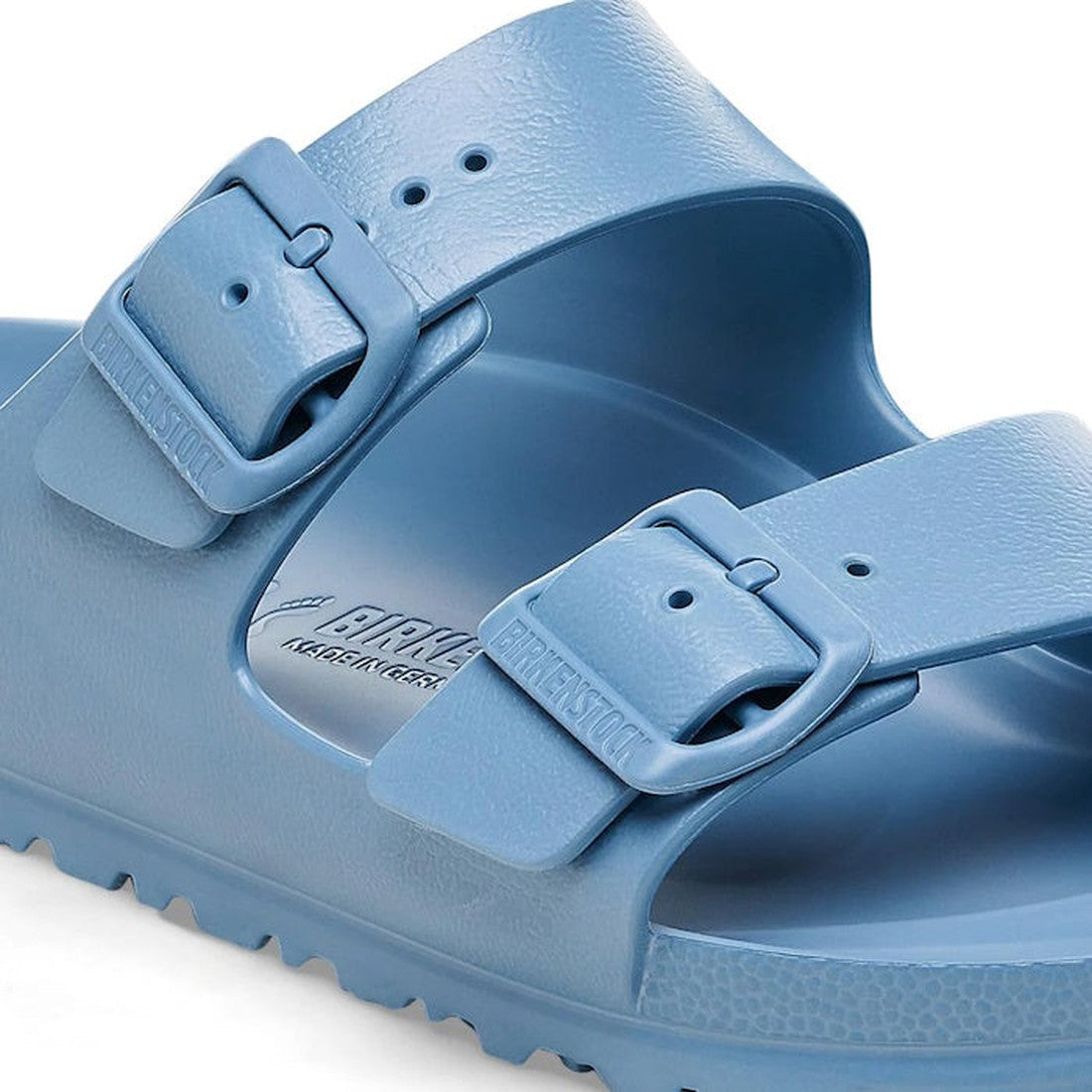 Close-up of a Birkenstock Arizona EVA Elemental Blue Narrow Width sandal with two adjustable buckle straps, a textured footbed, smooth waterproof material, and the brand name visible on the footbed., 4066648347804, 4066648347842, 4066648347880, 4066648347