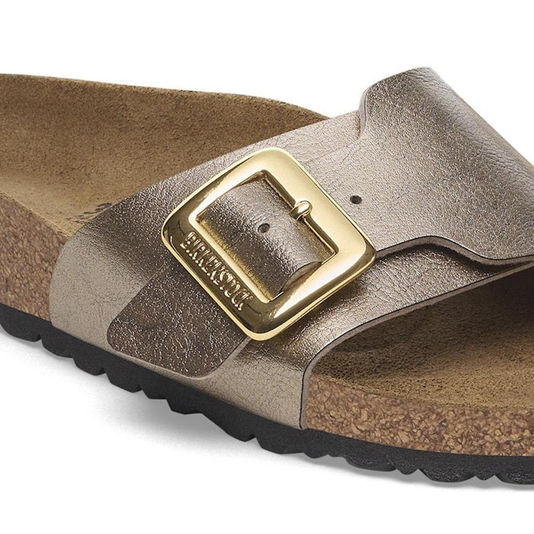 A close-up of the Birkenstock Womens Catalina Cushion Buckle sandal in Graceful Taupe Birko Flor, featuring a large metallic buckle, cork-latex footbed, and black textured rubber sole (Regular Width)., 4067707018482, 4067707018529, 4067707018567, 40677070