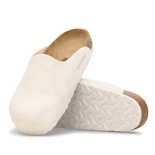 A pair of Birkenstock Amsterdam Felt Wool Glog Eggshell Off White Regular Width clogs, one upright and one on its side to show the textured white sole and cork-latex footbed.