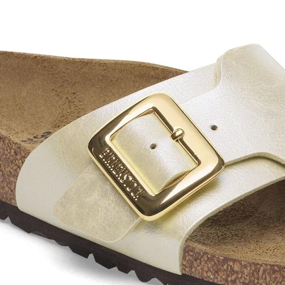 Close-up of the Birkenstock Womens Catalina Cushion Buckle sandal in Pearl White Birko-Flor, featuring a cork-latex contoured footbed, large shiny gold buckle on the strap, and a dark outsole. Regular width., 4066648995265, 4066648995302, 4066648995340, 4