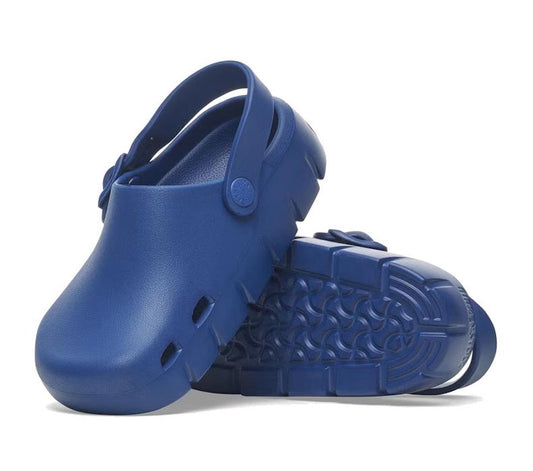 A pair of Birkenstock Kids EVA Navy Birki-Flow Clog Sandals—one upright, the other on its side—showing the supportive footbed, textured sole, and adjustable back strap.
