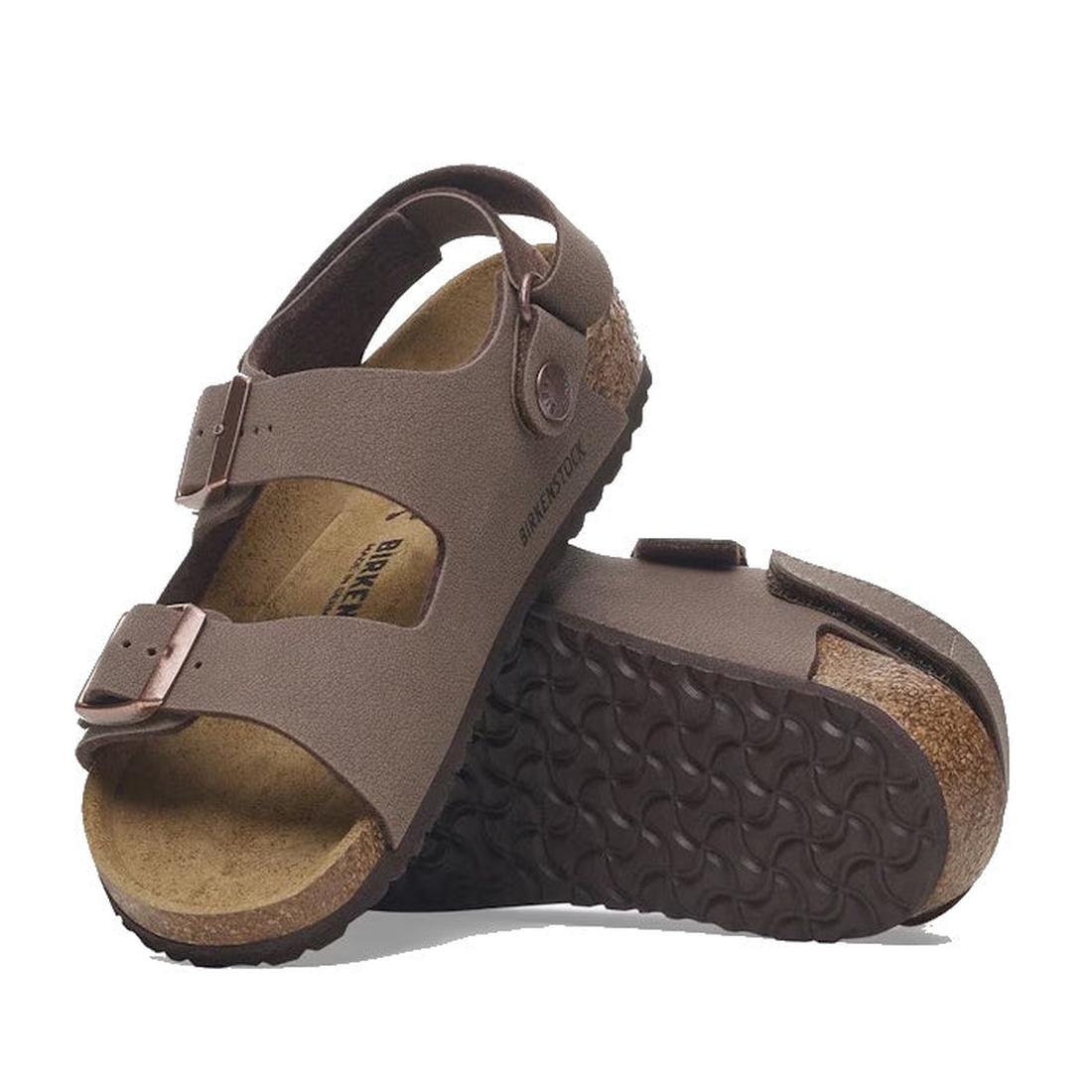 A pair of Birkenstocks Kids Milano AS Birkibuc Mocha Back Strap Sandals features two adjustable straps with buckles and a signature cork-latex footbed, with one sandal upright and the other showing the textured sole.