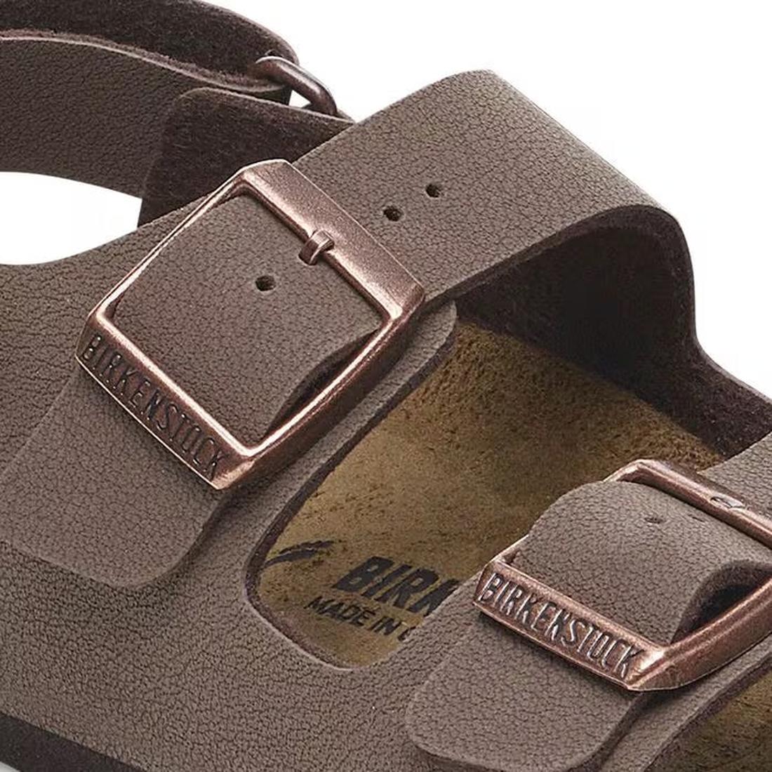 Close-up of Birkenstocks Kids Milano AS Birkibuc Mocha Back Strap Sandal with two adjustable Birkibuc straps, metal buckles bearing the logo, and a supportive cork-latex footbed. The sandal features a textured mocha finish., 47520, 47521, 47522, 406770704