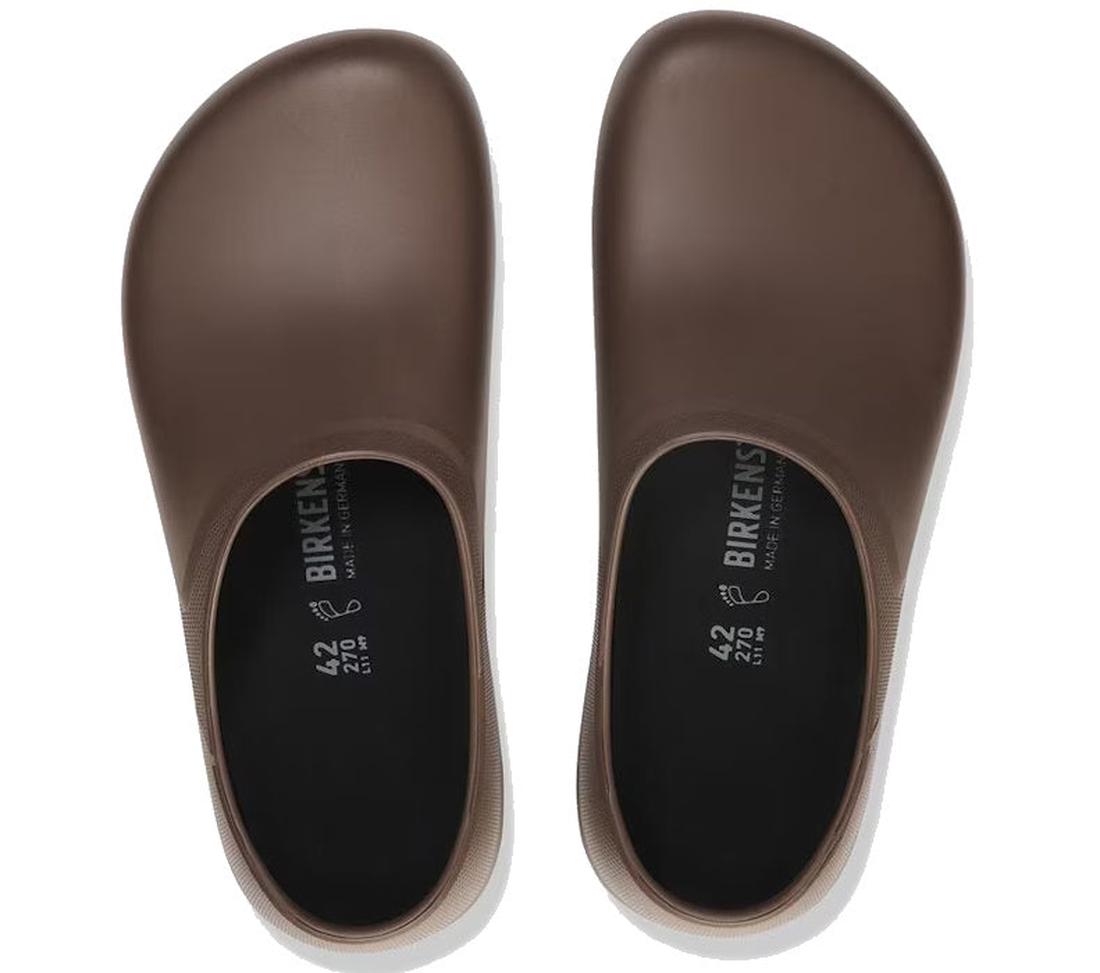 A pair of Birkenstock Profi Birki 2.0 Polyurethane Mocca Brown Regular Width slip-on shoes with rounded, closed toes are shown from above on a white background. The black inner soles display white size and brand details., 47704, 4061418843425, 40614188434
