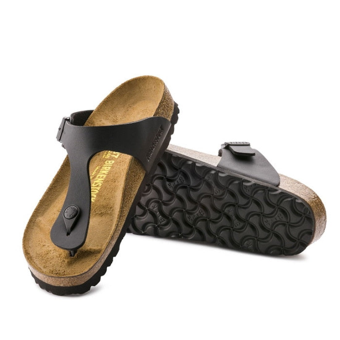 A pair of Birkenstock Gizeh Birko Flor Black Regular Width sandals with a cork footbed, single toe strap, and buckle. One sandal stands upright showing the textured sole; the other lies flat, displaying the comfy insole.