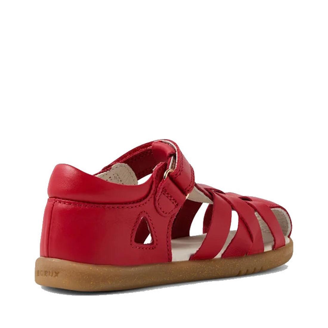 The Bobux Iwalk IW Tropicana II Salsa Red Leather Sandal for toddlers features a closed heel, open toe, Velcro strap, crisscross leather straps, and a brown rubber sole. Displayed on a white background., 9420074811202, 9420074811219, 9420074811226, 942007