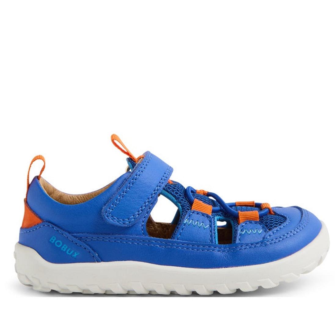 The Bobux IW Iwalk Rocky Dazzling Blue Closed Toe Sandal Barefoot is a kids’ sandal in blue and orange, with a barefoot-shaped toe box, white rugged sole, adjustable Velcro strap, and breathable cutout sides, shown from the side., 9420074837561, 942007483