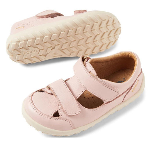 A pair of Bobux IW Iwalk Troop Toddlers Leather Sandal in Cameo Rose Pink, with Velcro straps and beige textured rubber soles, is displayed—one upright and the other showing the sole.