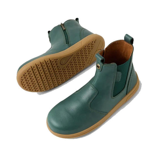 The Bobux KP Kids Plus Jodhpur 2 II Juniors Leather Boot in Rainforest Green features teal leather, tan rubber soles, elastic side panels, and pull tabs—one boot displays the gusset, the other the textured flexible sole.