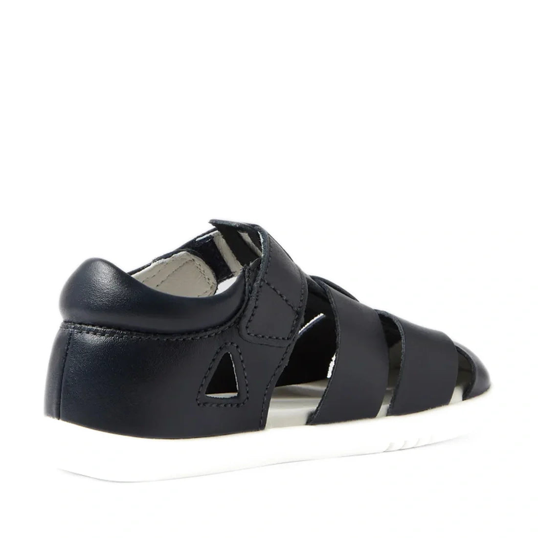 A navy Bobux IWalk Tidal Closed Toe Quick Dry Sandal (634404A), featuring cut-out sides, a closed heel, and a white sole, is shown from the back left angle against a white background.
