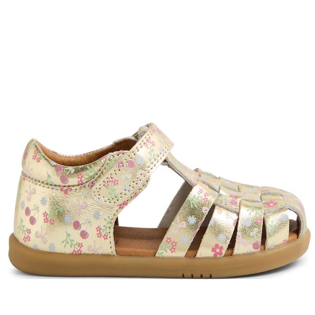 The Bobux IWalk Harbor Gold Foil Metallic Floral Print Sandal is a water-friendly leather toddler shoe with a closed heel, open toe, brown rubber sole, and Velcro ankle strap for durability and style.