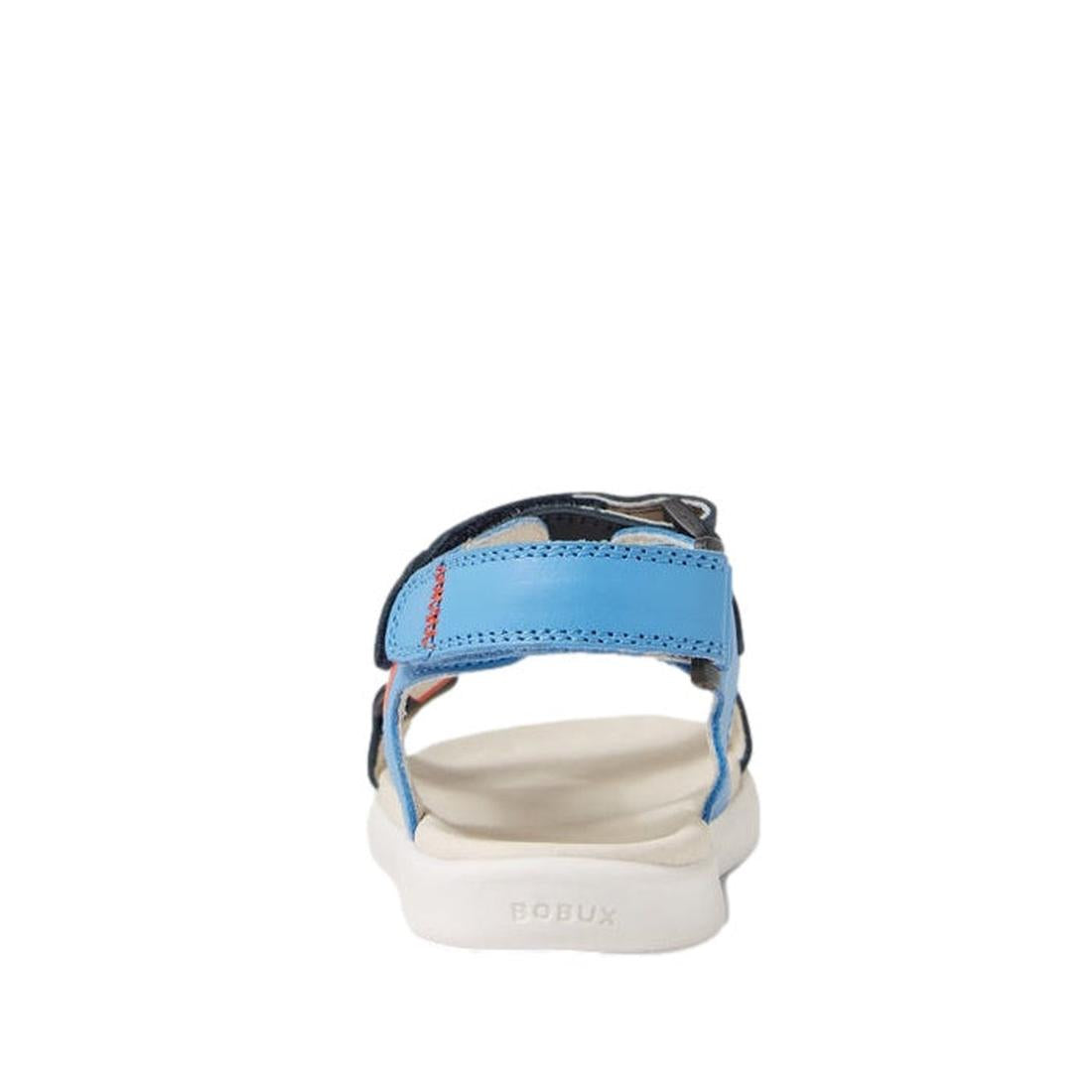 A rear view of the Bobux Kid+ Plus Vine Leather Navy Open Toe Sandal Junior, featuring a blue adjustable strap, white sole, visible stitching, and the BOBUX brand name embossed on the heel., 9420074820358, 9420074820365, 9420074820372, 9420074820389, 9420