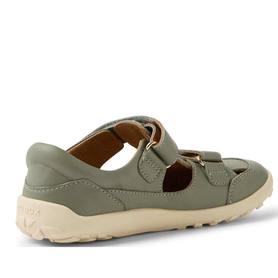 The Bobux Kid+ Troop Leather Closed Toe Sandal in Vetiver Green is a sage green leather children’s shoe with cut-out sides, wide toe box, beige flexible rubber sole, and two hook-and-loop straps for easy fastening and comfort., 9420074822802, 942007482281