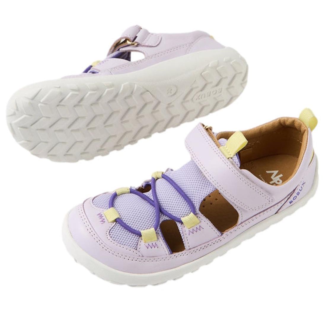 Bobux Kid+ Rocky Sandals in soft Thistle Lavender, closed toe, white zero-drop soles, yellow pull tabs, and easy hook-and-loop straps.  ksnz