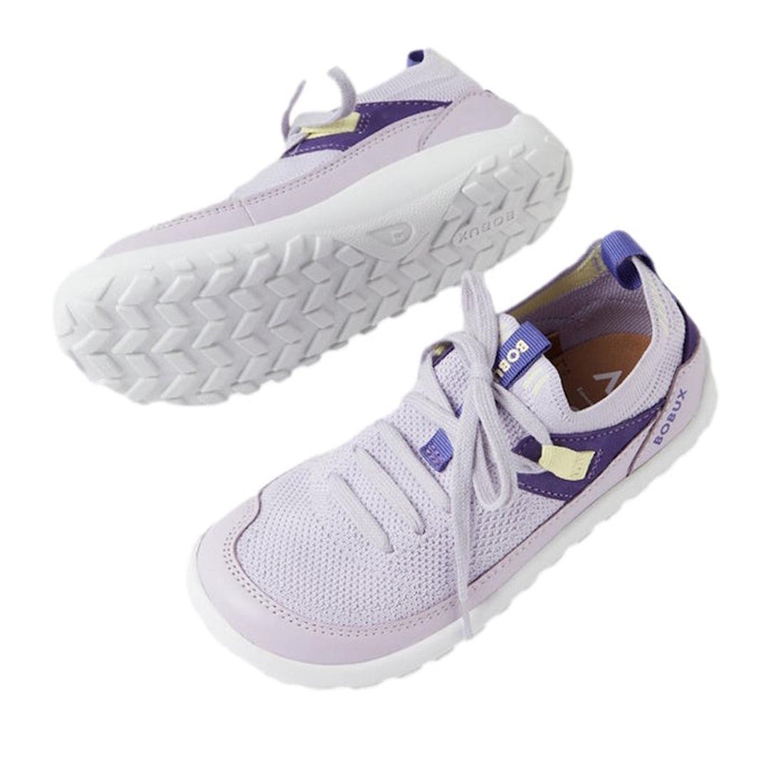 The Bobux Kid+ Meta Knit Barefoot Sneaker in Thistle Lavender for juniors features breathable mesh uppers, purple accents, white soles, and flexible non-slip outsoles. Displayed on a white background with one shoe upright and one sole shown., 942007483594