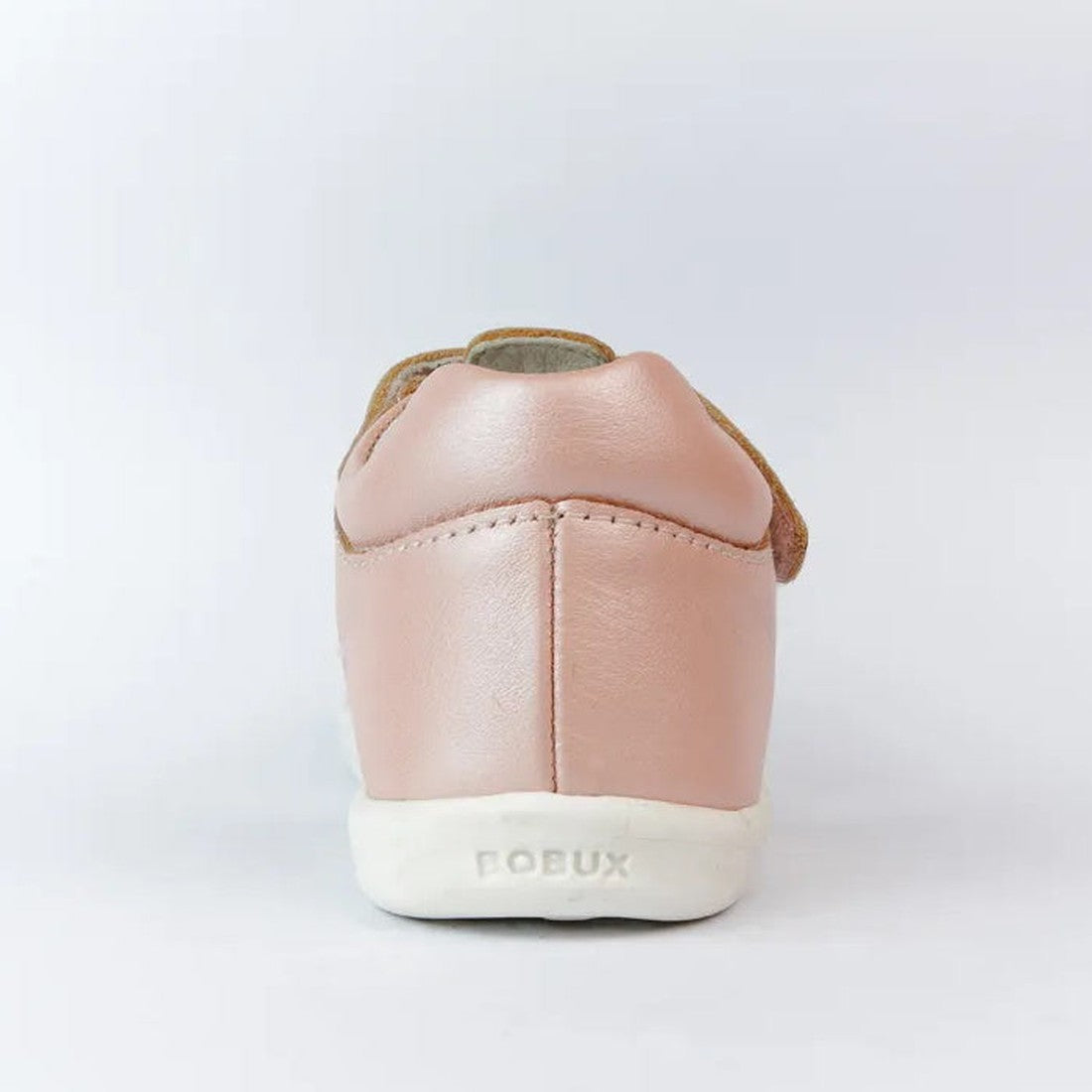 Rear view of the Bobux IW Iwalk Mirror Seashell Pink 633414C girls’ open-toed sandal, featuring pink leather and a white sole with “BOBUX” embossed on the heel. The background is plain and light-colored., 9420062022276, 9420062022283, 9420062022290, 94200