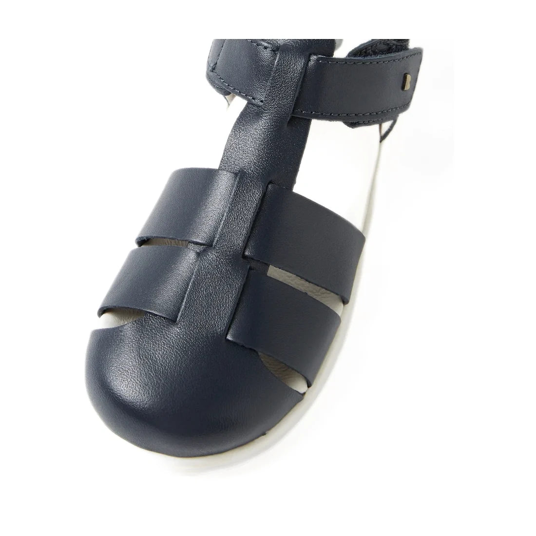 Close-up of the Bobux Kid + Plus Tidal Closed Toe Quick Dry Sandal Navy 834404A, featuring a navy blue design with a closed toe and two horizontal straps, crafted from Quick Dry Leather, shown against a white background.