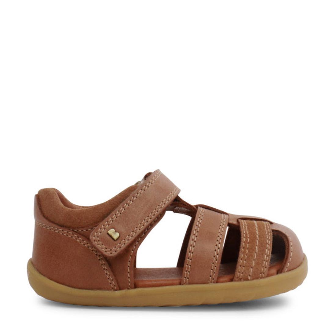 The Bobux Step Up Todders Sandal Roam 729204B in Caramel features a brown leather upper, closed heel, open toe, three front straps, and a hook-and-loop ankle strap—ideal first walking sandals—shown in profile on a white background., 15014, 9420062081464, 