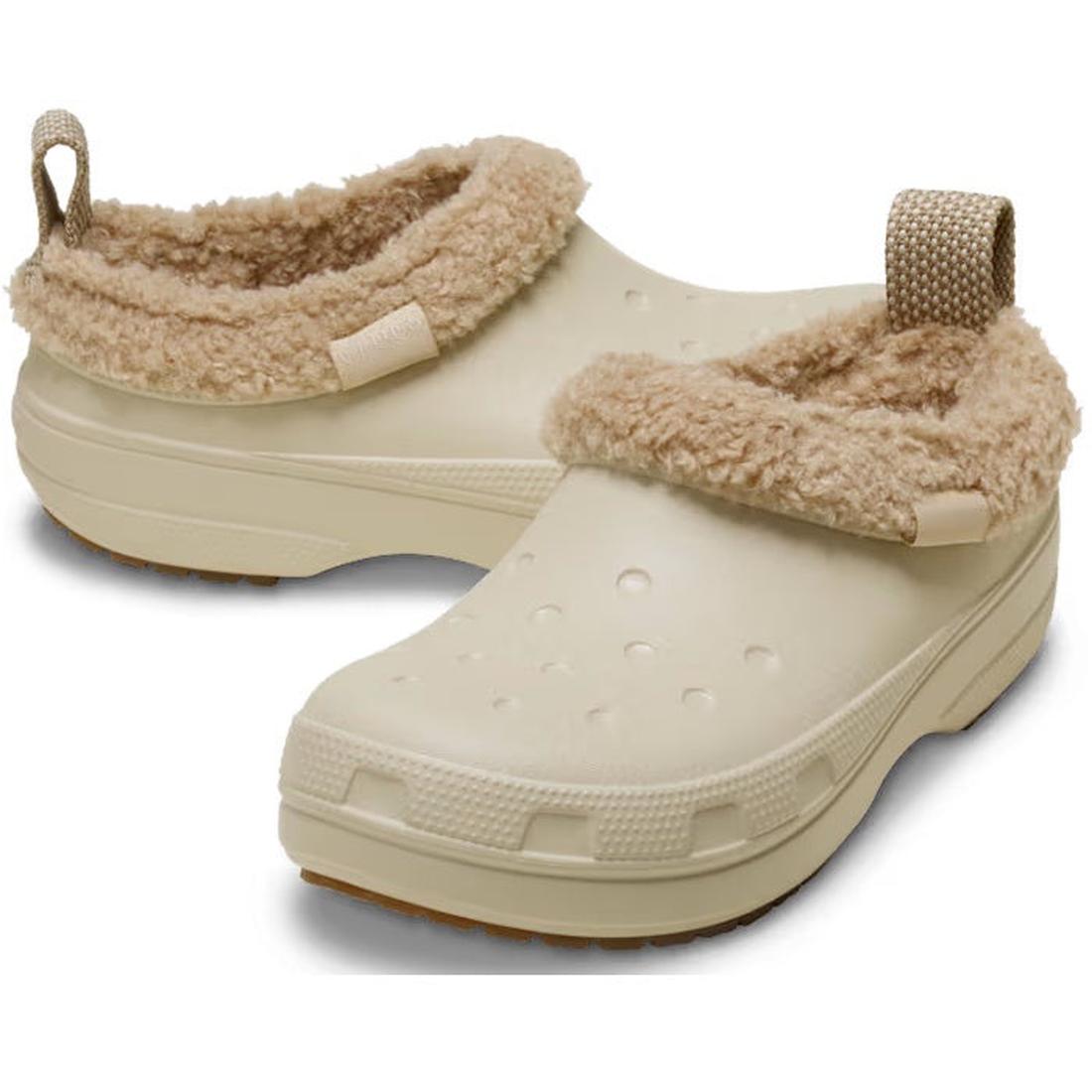 The Crocs Adults Classic Lined Shorty Clog in Sandstone Off White features a warm fuzzy liner, textured waterproof sole, and a back strap with pull tab for easy wear.