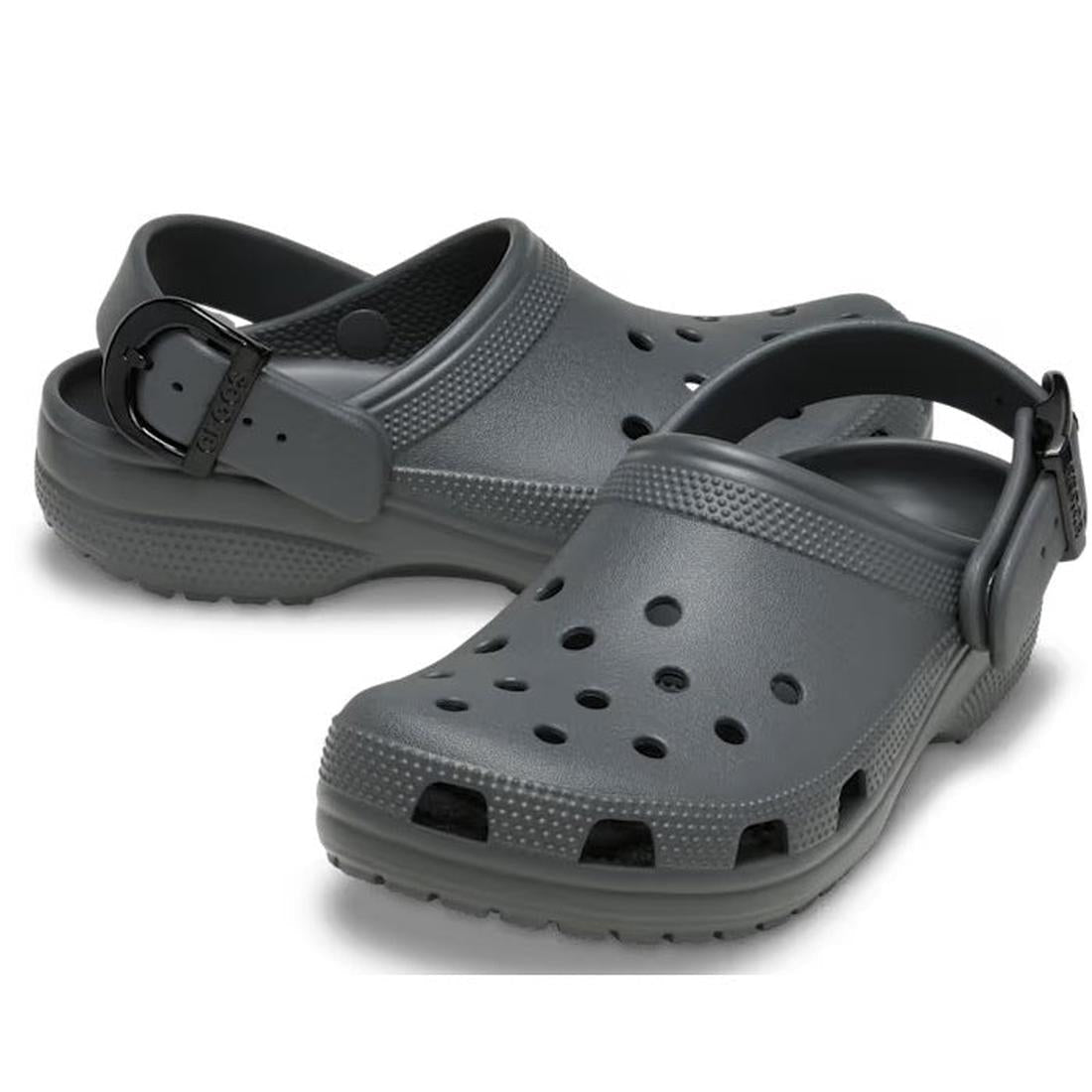 The Crocs Adults Classic Enamel Buckle Clog in Carbon Grey features ventilation holes, Croslite foam construction, and an adjustable backstrap, displayed against a white background.