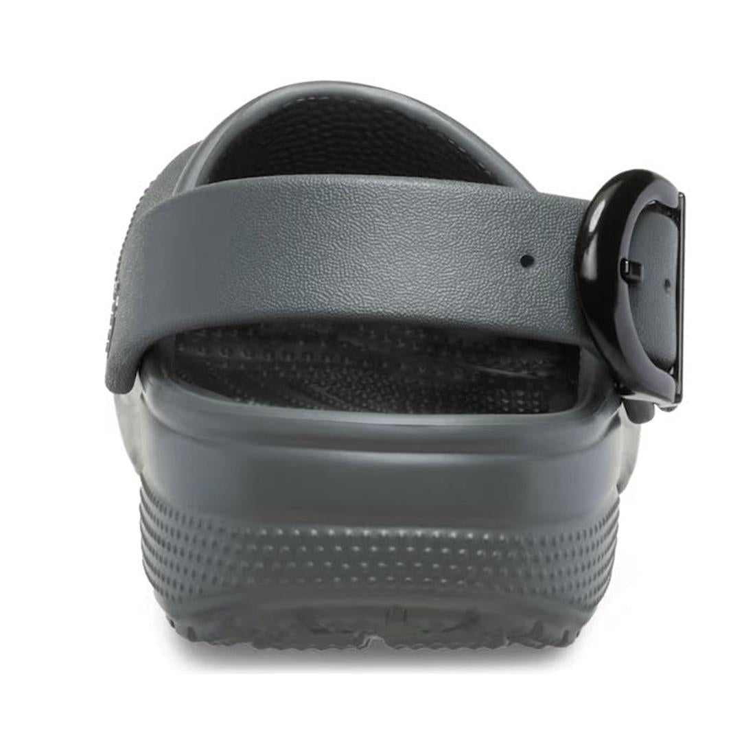 A close-up rear view of the Crocs Adults Classic Enamel Buckle Clog in Carbon Grey, featuring an adjustable backstrap with a black buckle and showcasing its textured sole and heel area., 51696, 198445415715, 198445415722, 198445415739, 51700, 51701