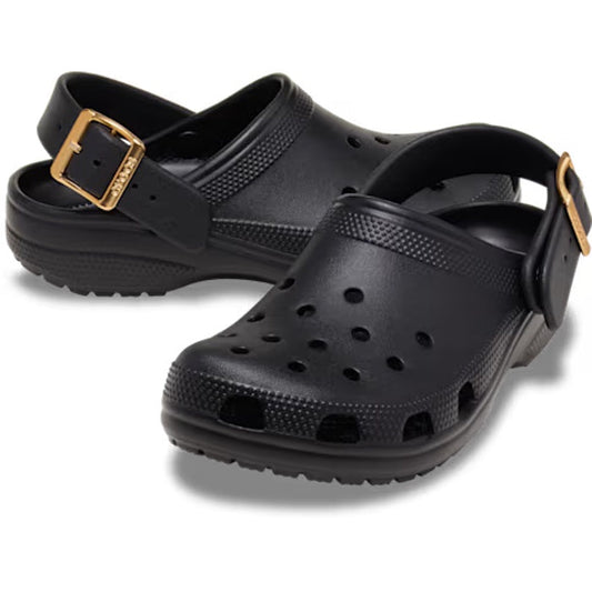 A pair of Crocs Womens Classic Metallic Buckle Clogs in black, featuring ventilation holes for breathability, gold buckle straps, and textured soles for enhanced grip. With the signature Crocs Comfort and an adjustable backstrap, each shoe is arranged so 