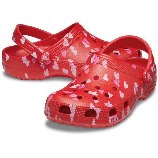 The Crocs Classic Valentines Day Clog Adults Unisex features heart lollipop and white-pink heart prints, ventilation holes, and an adjustable heel strap—perfect for a playful Valentine’s Day look.