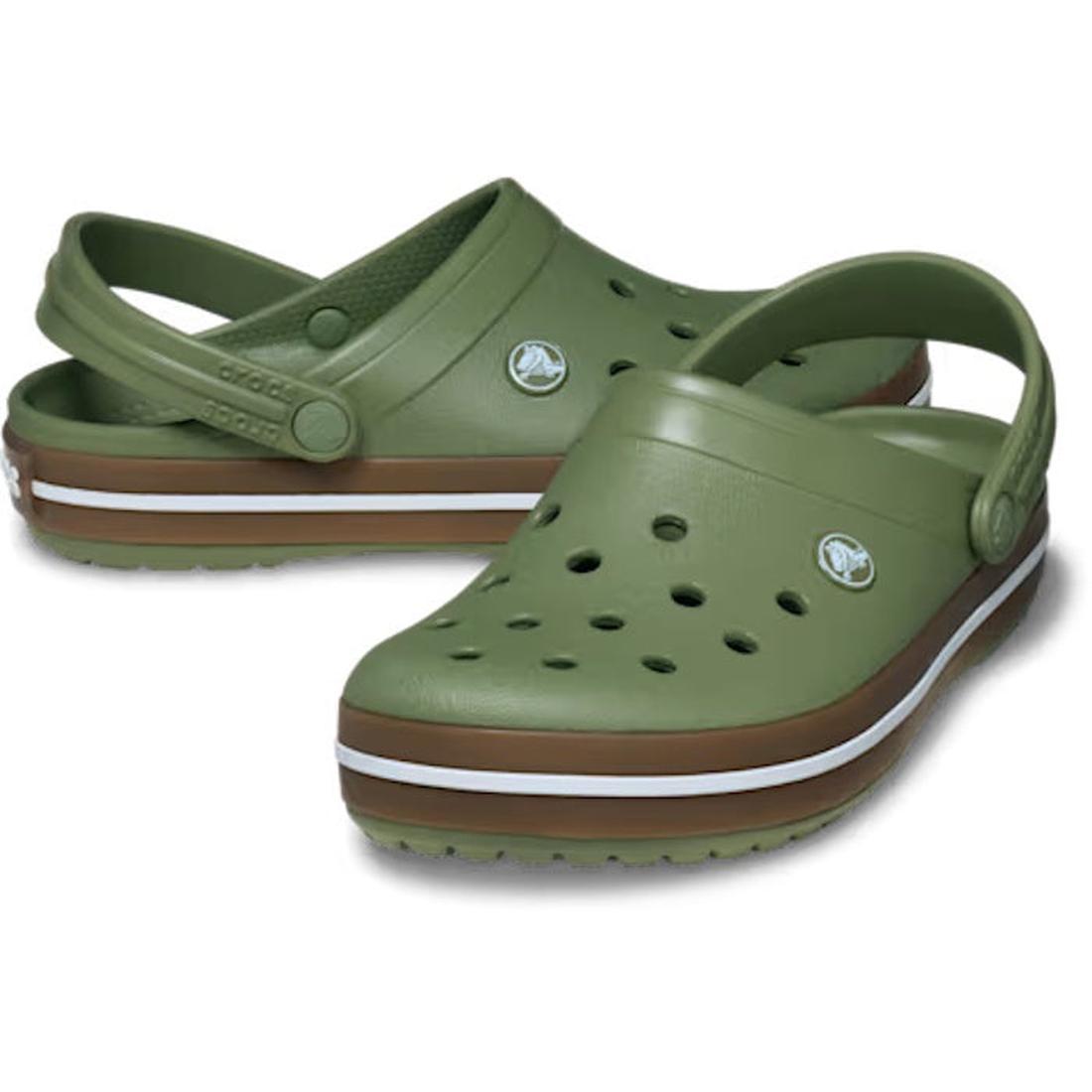 The Crocs Adults Crocband Gum Clog in Cargo Green features gum rubber band accents, white and brown striped soles, Croslite foam comfort, ventilation holes on top, and adjustable back straps.