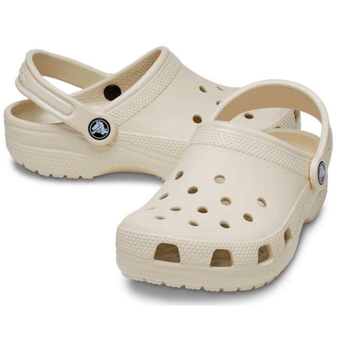 Crocs Kids - Toddlers Classic Clog K Bone, a comfy cream clog with grippy sole, airflow holes, and secure adjustable heel strap.  ksnz