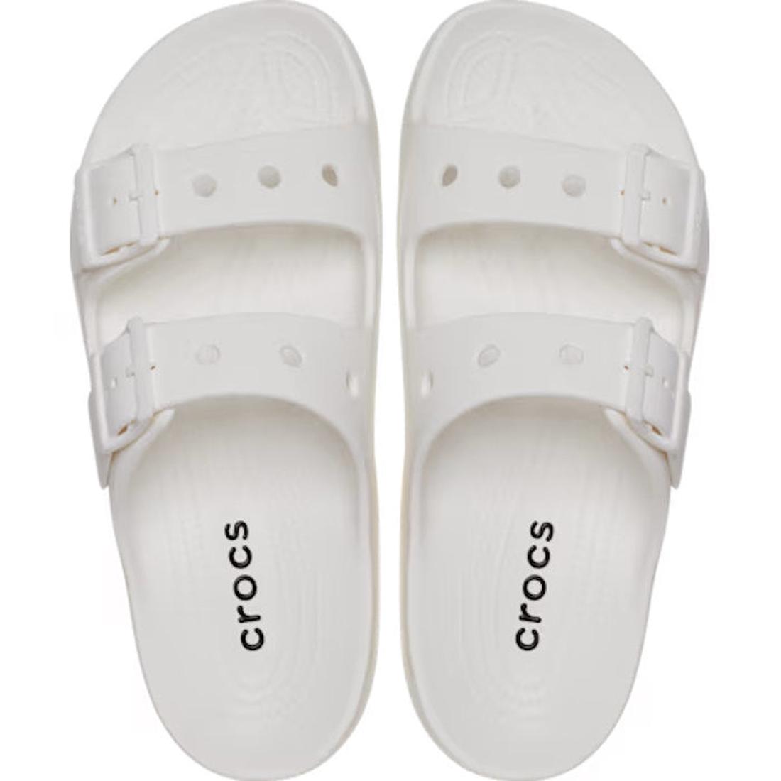 A pair of Crocs Womens Classic Saturday Sandal Slide White, featuring Crocs Comfort, two adjustable straps with buckles, and “crocs” printed in black on the footbeds, shown from above., 50014, 50015, 198445397431, 198445397448, 198445397455, 50019, 50020