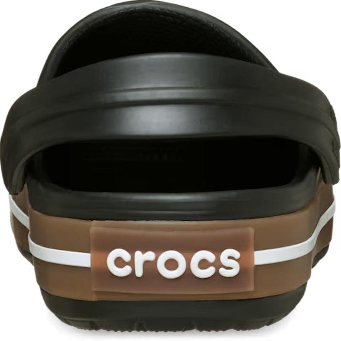 Close-up of the Crocs Adults Crocband Gum Clog Black Unisex, highlighting its Croslite foam comfort, white stripe detail, and "crocs" in white lettering on a brown heel tab., 50028, 198445372889, 198445372896, 198445372902, 198445372919, 198445372926, 198, 198445372834, 198445372841, 198445372858, 198445372865