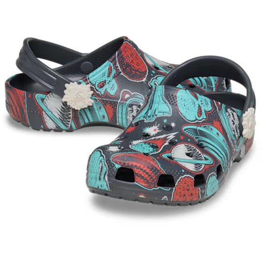 Dark gray Crocs Kids Classic Clog Space Monster Junior Youth sandals with a cartoon space and monster print featuring red and blue planets, aliens, and stars.