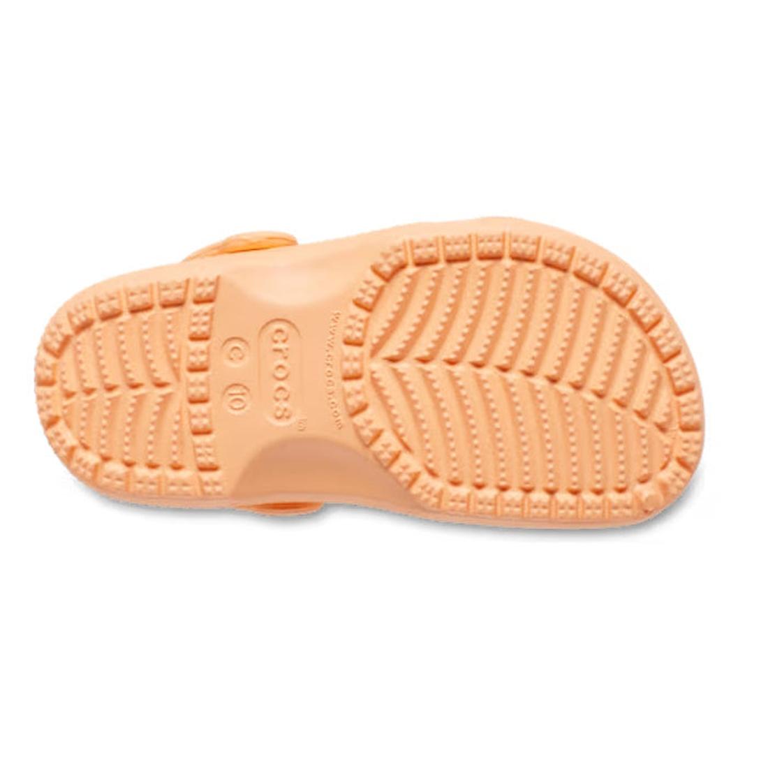 The image displays the sole of a Crocs Kids Toddlers Classic Clog in Electric Sunstone, with its textured tread for grip and the Crocs logo centered, shown facing upward., 49131, 198445270024, 198445270031, 198445270048, 198445270055, 198445269998