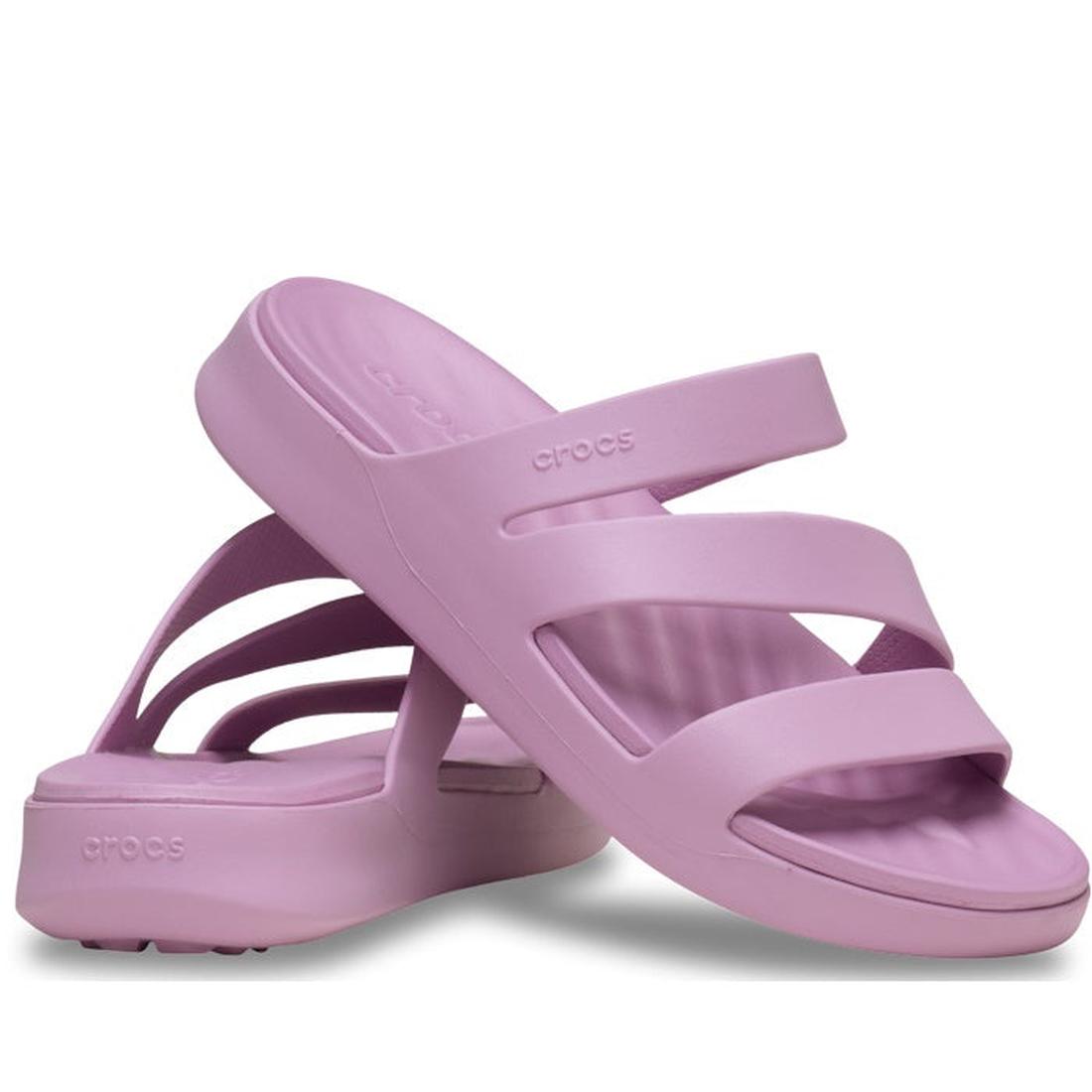 The Crocs Womens Getaway Strappy Hydrangea Purple Slide features three molded rubber-like straps and Free Feel Technology. Shown in light purple, these sandals are from the Crocs Getaway Collection and displayed against a white background.