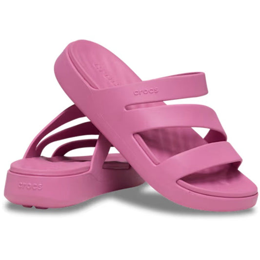 A pair of Crocs Womens Getaway Strappy Quiet Rose Slides from the Crocs Getaway Collection, featuring three straps across the top for a stylish women’s strappy sandal look—one slide standing upright and the other leaning against it on a white background. 
