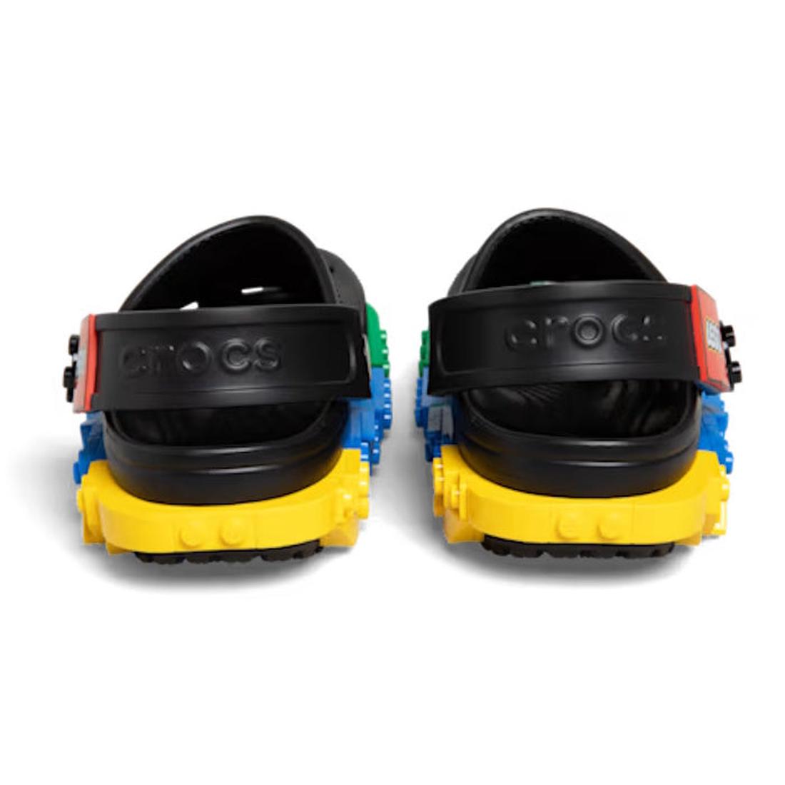 A pair of Crocs Kids’ LEGO® Creativity Clog Black Multi shoes, featuring colorful block accents on the soles and sides, are viewed from the back against a white background; these playful clogs are fully customizable with Jibbitz charms., 52891, 52892, 198