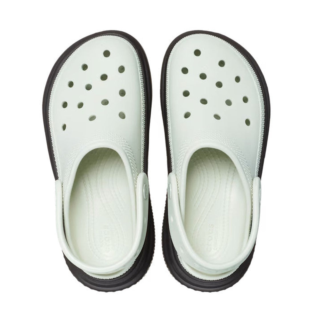 A pair of Crocs Stomp Classic Clog Adults Black Linen 2 Tone Platform, featuring light green uppers with ventilation holes and chunky black soles. The right shoe’s heel strap is up; the left’s strap is down, viewed from above., 38834, 196265753932, 196265