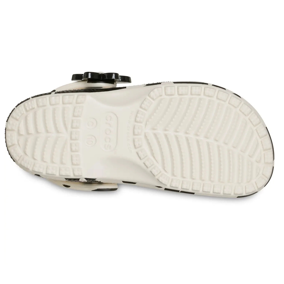The image shows the bottom view of a Crocs Kids Toddlers Classic Clog K Pop Petals in Off White Black, featuring visible tread patterns and the Crocs logo embossed in the center, highlighting signature Crocs Comfort in every step., 198445518065, 198445518
