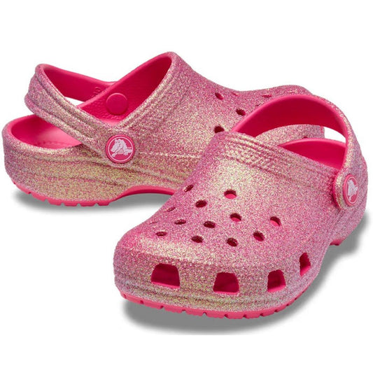 Crocs Kids - Youths Classic Clog K Iridescent Glitter Dragon Fruit shines in sparkly pink, with comfy sole, airy holes, and secure strap.  ksnz