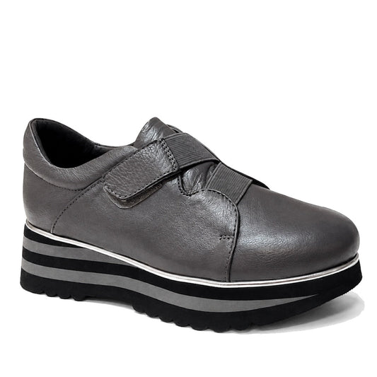 The Django & Juliette Ellore Charcoal Grey Leather Platform Shoe for women features a cushioned, rounded toe, velcro strap, and thick black-and-white striped sole for a stylish and comfortable casual look.