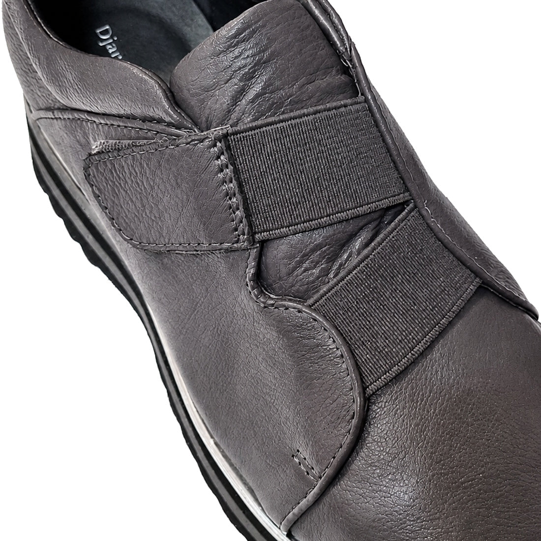 Close-up of the Django & Juliette Ellore Charcoal Grey Leather Platform Shoe for women, featuring elastic bands across the top and a black rubber sole, highlighting its texture and detailed stitching., 51103, 4434754334016, 4434754334023, 4434754334030, 4