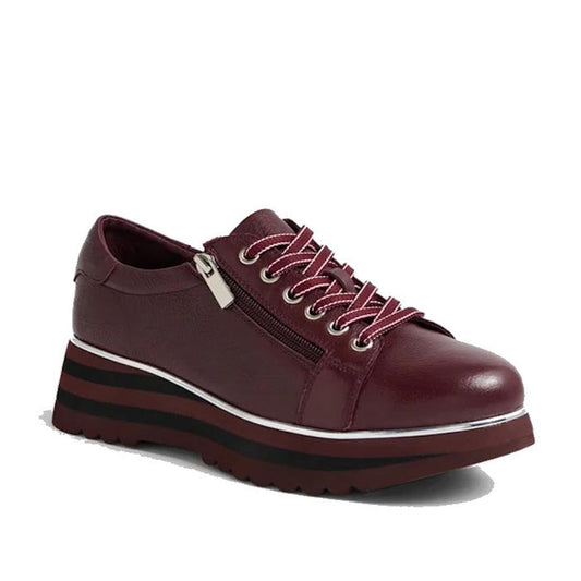 The Django & Juliette Eammes Purple Black Leather Platform Shoe for women features pink laces, silver eyelets, a side zipper, and a chunky maroon and black striped sole, displayed on a plain white background.