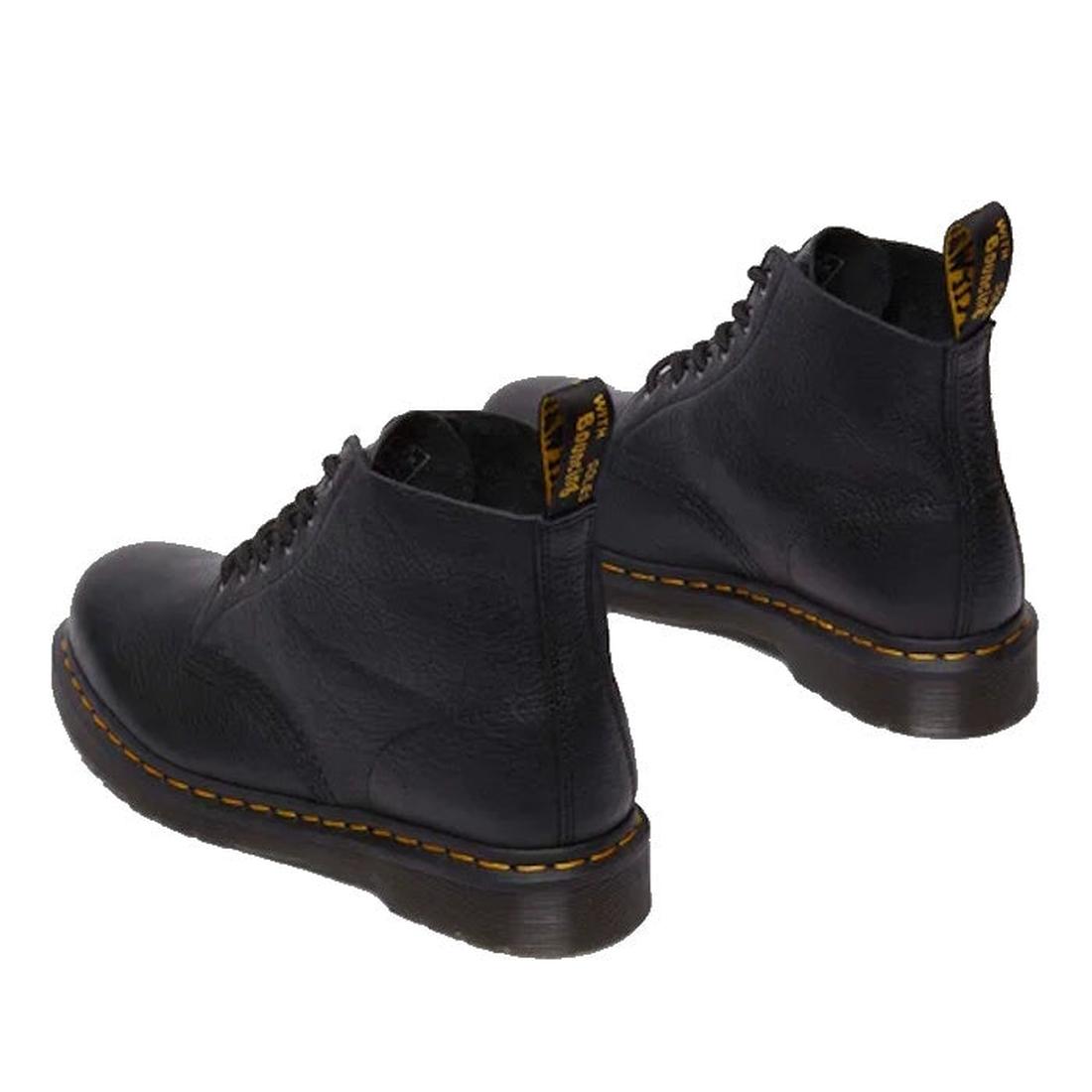 The Dr Martens 101 UB Black Ambassador 6 Eye Leather Boot features black leather, yellow stitching around the soles, and black pull tabs, shown from the back on a white background., 190665693683, 190665693690, 190665693706, 190665693720, 190665693737, 190