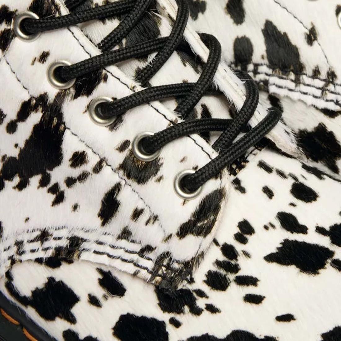 Close-up of the Dr Martens 1460 Bex Dalmatian Hair On Leather Lace Up Boot, featuring black laces, a white upper with black and brown cow-print spots, detailed stitching, eyelets, and a durable Goodyear welted sole., 190665780307, 190665780314, 1906657803