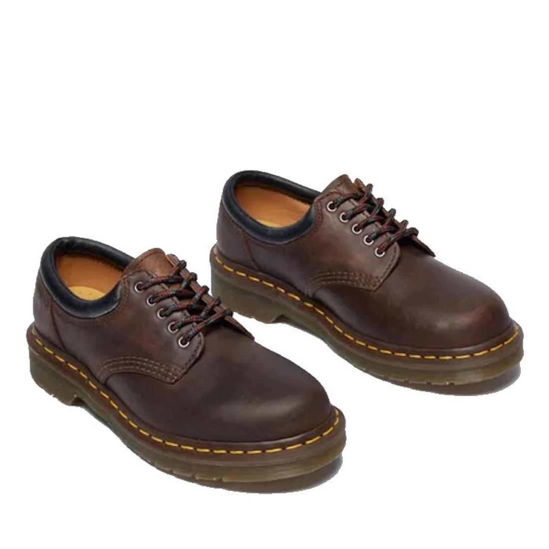 The Dr Martens 8053 Crazy Horse Dark Brown Leather 5 Eye shoe is a unisex lace-up with black trim, visible stitching, and thick air-cushioned rubber soles featuring yellow stitching around the edges., 52072, 52073, 800090801651, 800090801675, 800090801682